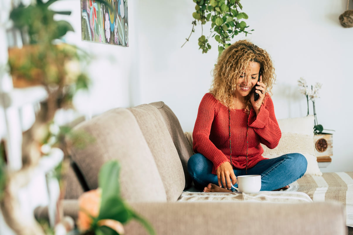 Smiling Woman at Home Talking on the Phone