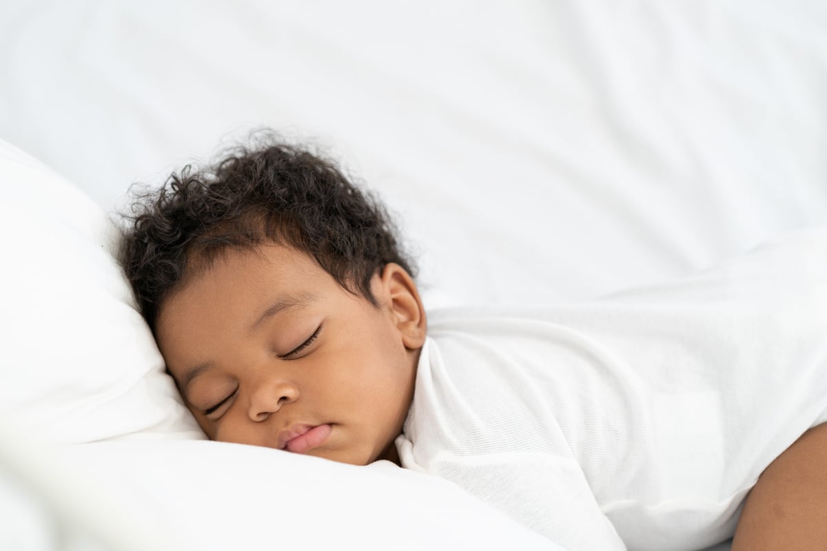 Baby Sleeping on White Mattress